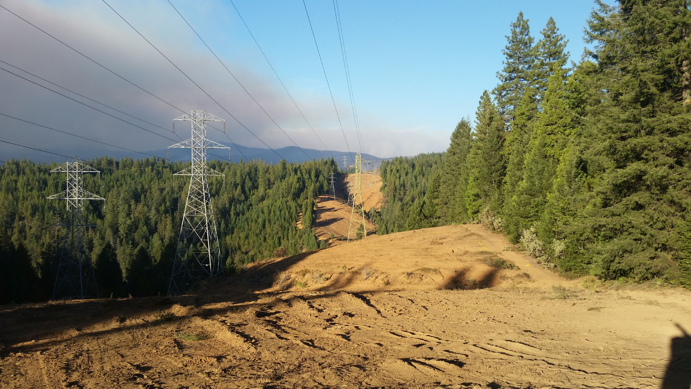 Man Using Measuring Tape in Factory Setting Man Using Measuring Tape in Factory Setting